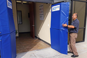 Eduardo Aguilera, Commercial Dispatcher, installing one of their many sets of Mat-A-Doors®