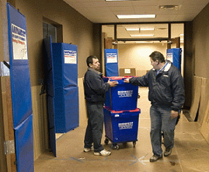 To a moving company, a real hall of fame gets through an office move without damage. Here, Luis Toledo, right, inspects Midwest's "hall of no claims" which features Masonite-covered floors, Koroflex on the walls, and Mat-A-Doors® protecting the double entrance doors on both sides of the lobby as well as the lobby side of the passenger/swing elevator. When working in an office building, Midwest Moving behaves as a guest that wants to be invited back. Therefore, they go to great lengths to minimize the risk of damage to floors, walls, doors and elevator entrances.